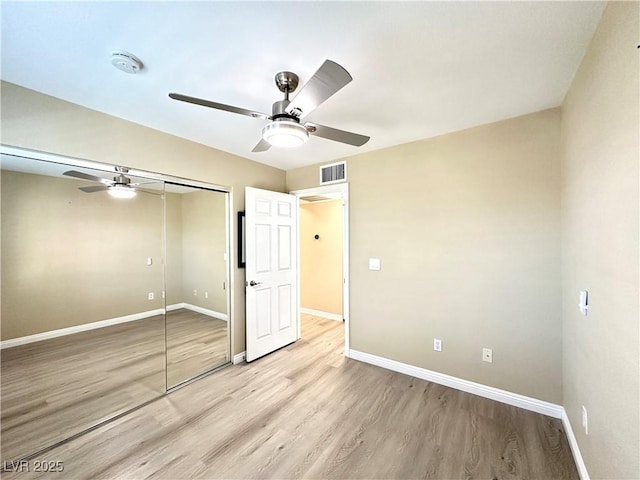 8070 W Russell Rd Unit 2070, Las Vegas, NV 89113 - unfurnished bedroom with light wood-type flooring, a closet, and a ceiling fan