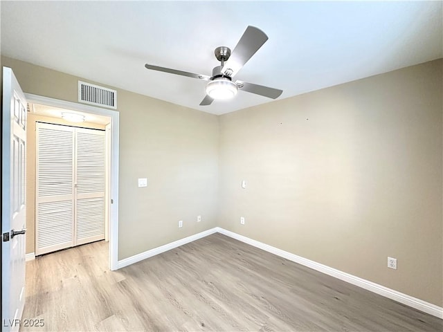 8070 W Russell Rd Unit 2070, Las Vegas, NV 89113 - unfurnished bedroom with light wood-style floors, ceiling fan, and a closet