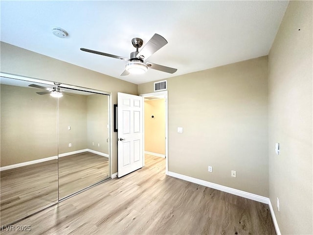 8070 W Russell Rd Unit 2070, Las Vegas, NV 89113 - unfurnished bedroom with a closet, light wood finished floors, and ceiling fan