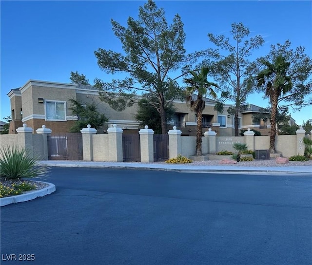8070 W Russell Rd Unit 2070, Las Vegas, NV 89113 - view of front facade with a fenced front yard, stucco siding, and a gate