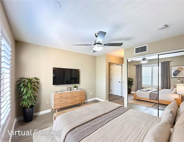 8070 W Russell Rd Unit 2070, Las Vegas, NV 89113 - bedroom with light wood-style flooring, a ceiling fan, and a closet