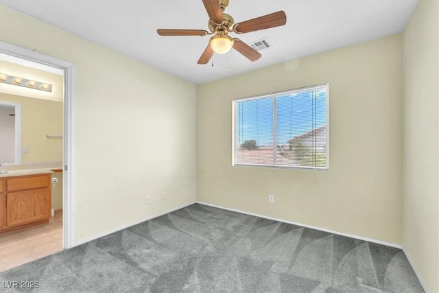9948 Trailing Vine St, Las Vegas, NV 89183 - unfurnished bedroom with light carpet, ensuite bath, and a ceiling fan