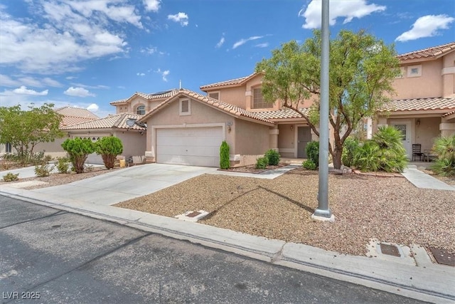 9948 Trailing Vine St, Las Vegas, NV 89183 - mediterranean / spanish-style home with stucco siding, a garage, concrete driveway, and a tiled roof
