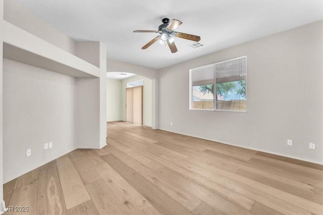9948 Trailing Vine St, Las Vegas, NV 89183 - spare room with arched walkways, light wood-style floors, and ceiling fan