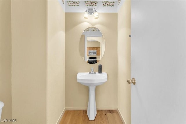 9948 Trailing Vine St, Las Vegas, NV 89183 - half bathroom with wood finished floors and baseboards