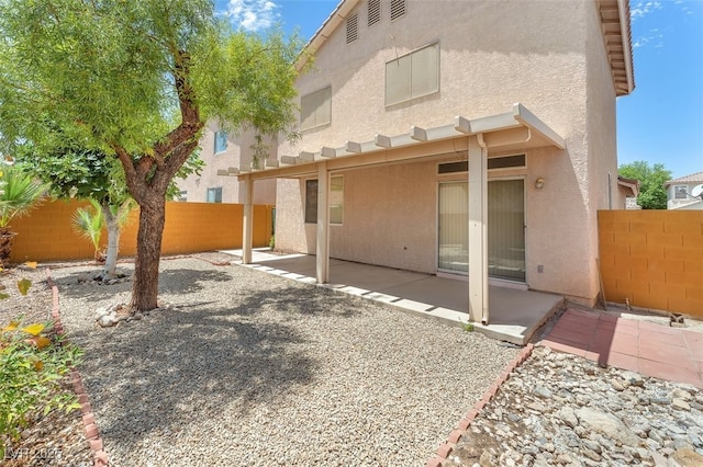 9948 Trailing Vine St, Las Vegas, NV 89183 - rear view of house featuring stucco siding, a fenced backyard, and a patio