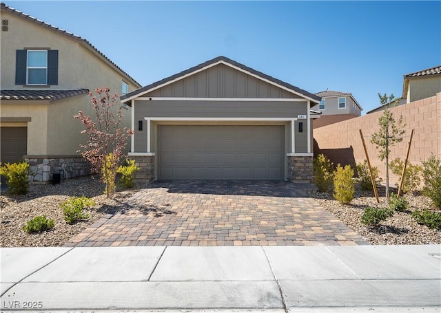 3447 Covilha Ln, Henderson, NV 89044 - view of front of home with stone siding, decorative driveway, and a garage