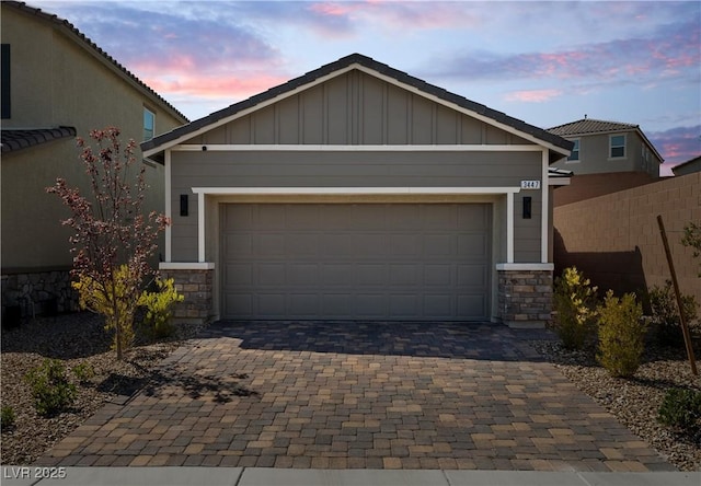 3447 Covilha Ln, Henderson, NV 89044 - view of front facade with stone siding, decorative driveway, and board and batten siding