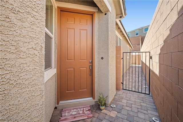 3447 Covilha Ln, Henderson, NV 89044 - property entrance with stucco siding and a gate