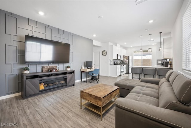 3447 Covilha Ln, Henderson, NV 89044 - living room featuring light wood finished floors, a desk, and recessed lighting