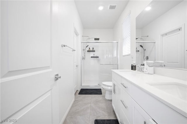 3447 Covilha Ln, Henderson, NV 89044 - bathroom featuring a stall shower, double vanity, recessed lighting, and tile patterned flooring