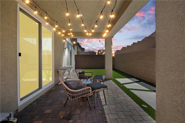 3447 Covilha Ln, Henderson, NV 89044 - patio terrace at dusk featuring a fenced backyard and a patio