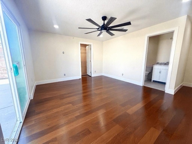 612 Brush St, Las Vegas, NV 89107 - unfurnished bedroom with dark wood-type flooring, connected bathroom, a ceiling fan, and recessed lighting