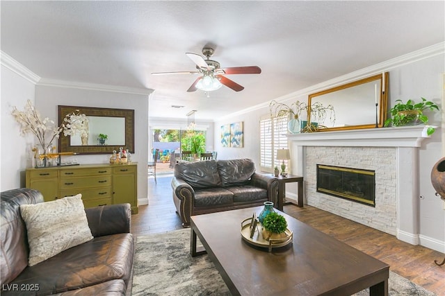 3024 Pier Harbor Dr, Las Vegas, NV 89117 - living room featuring ceiling fan, wood finished floors, crown molding, and a stone fireplace