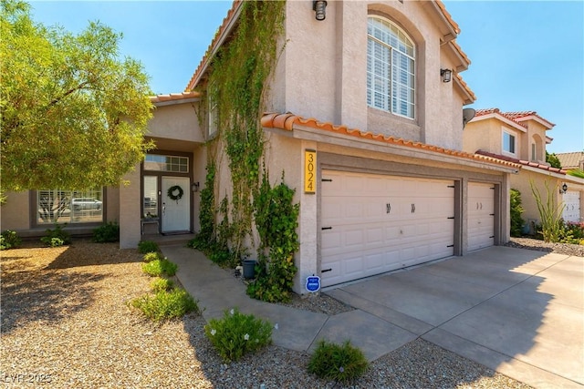 3024 Pier Harbor Dr, Las Vegas, NV 89117 - view of front of house with concrete driveway, a tile roof, stucco siding, and a garage