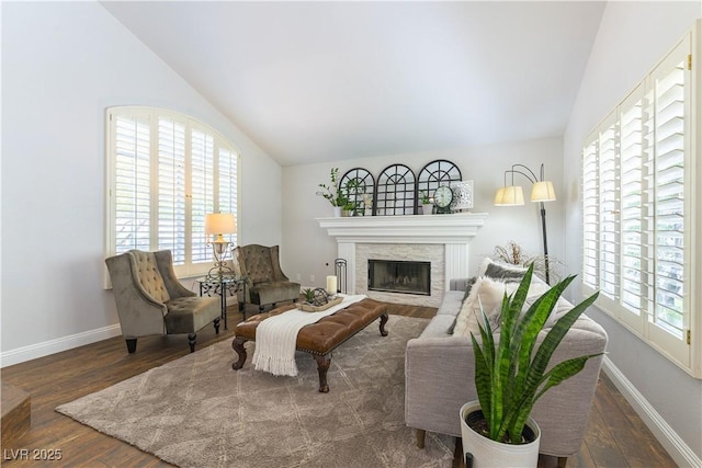 3024 Pier Harbor Dr, Las Vegas, NV 89117 - living area featuring lofted ceiling, wood finished floors, and a stone fireplace