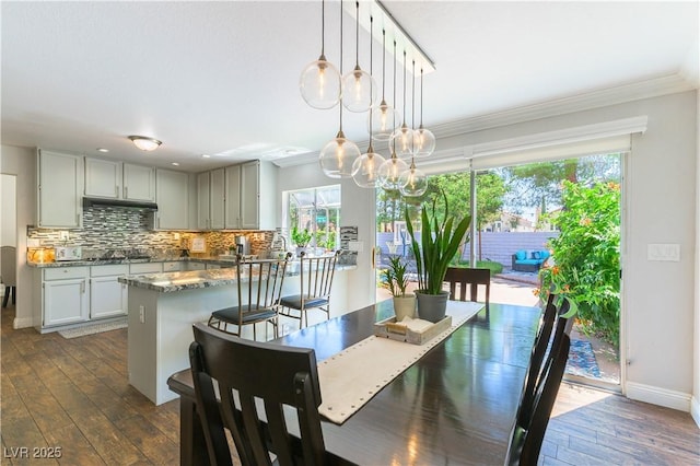 3024 Pier Harbor Dr, Las Vegas, NV 89117 - dining space with healthy amount of natural light, crown molding, dark wood-type flooring, and a chandelier