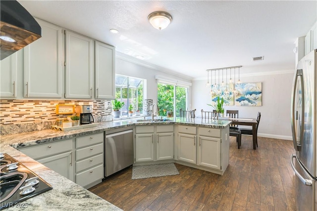 3024 Pier Harbor Dr, Las Vegas, NV 89117 - kitchen featuring a peninsula, appliances with stainless steel finishes, crown molding, dark wood-style flooring, and exhaust hood