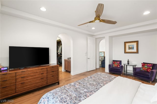 2310 Malaga Peak St, Las Vegas, NV 89135 - bedroom with arched walkways, recessed lighting, light wood-style floors, a spacious closet, and a ceiling fan