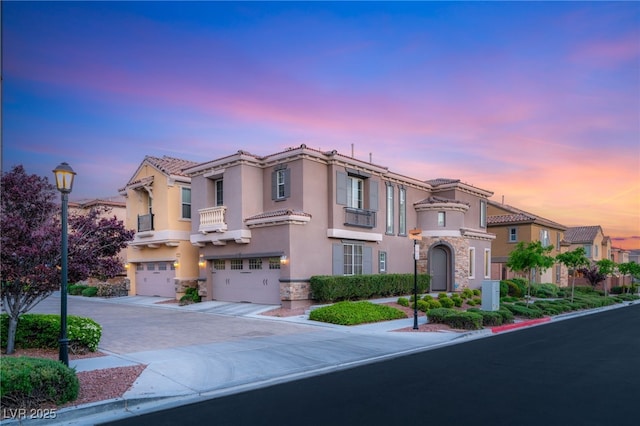 2310 Malaga Peak St, Las Vegas, NV 89135 - view of front of house with stone siding, driveway, a garage, and stucco siding