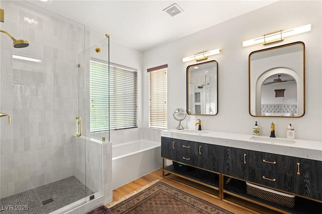 2310 Malaga Peak St, Las Vegas, NV 89135 - full bathroom with a stall shower, a bath, double vanity, and wood finished floors