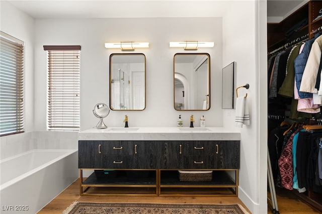 2310 Malaga Peak St, Las Vegas, NV 89135 - full bath with wood finished floors, double vanity, a bath, and a spacious closet