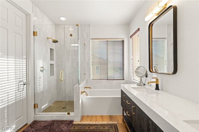 2310 Malaga Peak St, Las Vegas, NV 89135 - bathroom with double vanity, a bath, wood finished floors, plenty of natural light, and recessed lighting