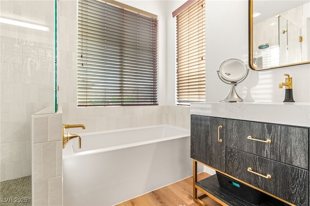 2310 Malaga Peak St, Las Vegas, NV 89135 - bathroom featuring a bath, walk in shower, vanity, and wood finished floors