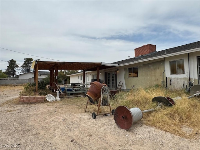 2583 Emerald Ave, Las Vegas, NV 89120 - rear view of house with a chimney, stucco siding, a pergola, roof with shingles, and a patio area