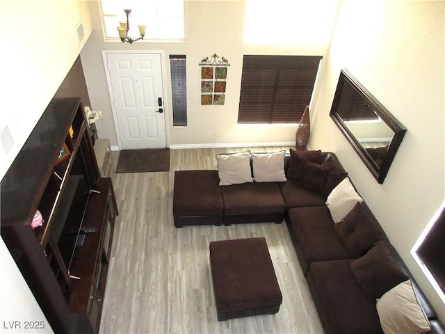10013 Solid Lime St, Las Vegas, NV 89183 - living room featuring wood finished floors and a chandelier