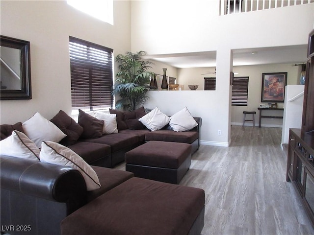 10013 Solid Lime St, Las Vegas, NV 89183 - living area featuring wood finished floors, a towering ceiling, and ceiling fan
