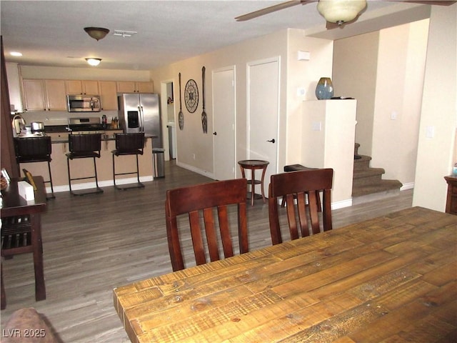 10013 Solid Lime St, Las Vegas, NV 89183 - dining room featuring dark wood-style flooring, stairway, and ceiling fan