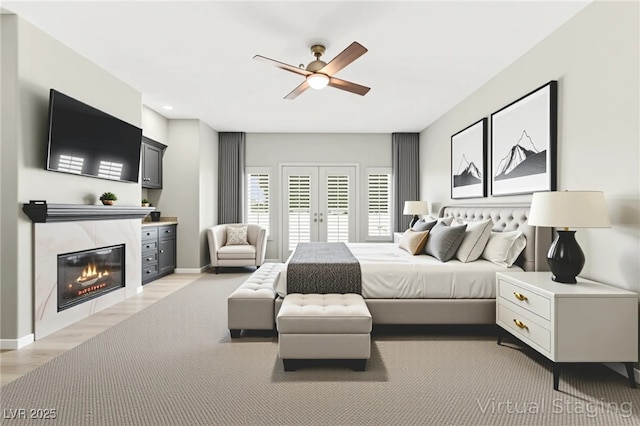 1800 Aztec Cliffs Ct, Las Vegas, NV 89128 - bedroom featuring a tiled fireplace, french doors, ceiling fan, and light wood finished floors