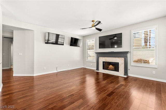 1800 Aztec Cliffs Ct, Las Vegas, NV 89128 - unfurnished living room featuring a ceiling fan, a high end fireplace, plenty of natural light, and wood finished floors