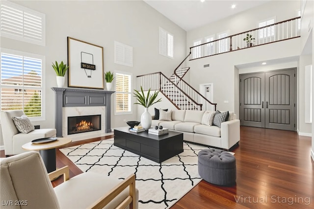 1800 Aztec Cliffs Ct, Las Vegas, NV 89128 - living area with a towering ceiling, dark wood-style floors, a fireplace, stairway, and recessed lighting