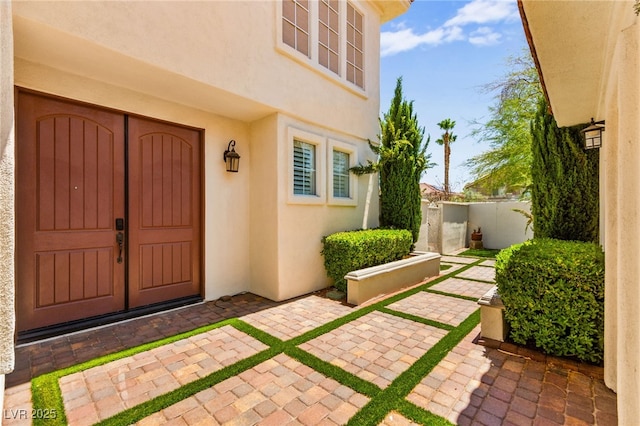 1800 Aztec Cliffs Ct, Las Vegas, NV 89128 - entrance to property with stucco siding and a patio area