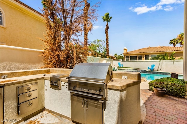 1800 Aztec Cliffs Ct, Las Vegas, NV 89128 - fenced backyard with an outdoor kitchen and a patio