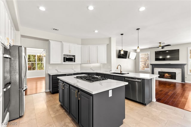 1800 Aztec Cliffs Ct, Las Vegas, NV 89128 - kitchen with appliances with stainless steel finishes, white cabinetry, a center island, open floor plan, and ceiling fan