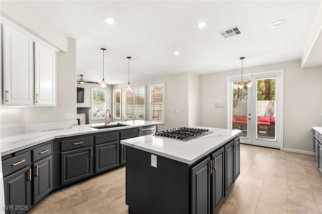 1800 Aztec Cliffs Ct, Las Vegas, NV 89128 - kitchen with appliances with stainless steel finishes, white cabinetry, healthy amount of natural light, recessed lighting, and a kitchen island