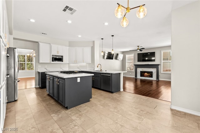 1800 Aztec Cliffs Ct, Las Vegas, NV 89128 - kitchen featuring stainless steel appliances, a kitchen island, healthy amount of natural light, a ceiling fan, and recessed lighting