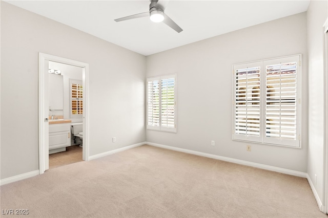 1800 Aztec Cliffs Ct, Las Vegas, NV 89128 - unfurnished bedroom with light colored carpet, connected bathroom, and a ceiling fan