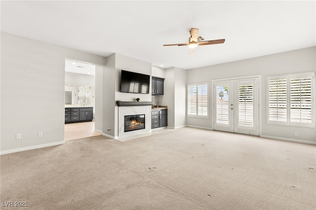1800 Aztec Cliffs Ct, Las Vegas, NV 89128 - unfurnished living room with light colored carpet, a ceiling fan, and a fireplace with flush hearth