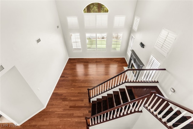 1800 Aztec Cliffs Ct, Las Vegas, NV 89128 - staircase with a high ceiling, plenty of natural light, and wood finished floors