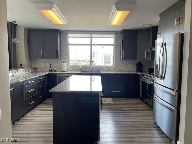 150 Las Vegas Blvd Unit 1115, Las Vegas, NV 89101 - kitchen featuring appliances with stainless steel finishes, backsplash, light wood-style floors, and light stone countertops