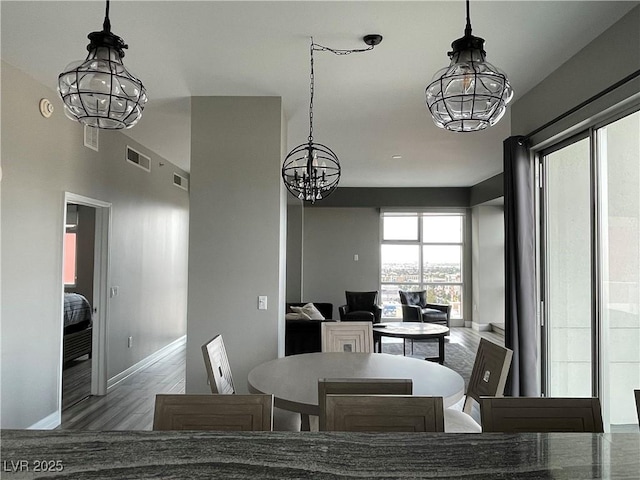 150 Las Vegas Blvd Unit 1115, Las Vegas, NV 89101 - dining area featuring a chandelier and wood finished floors