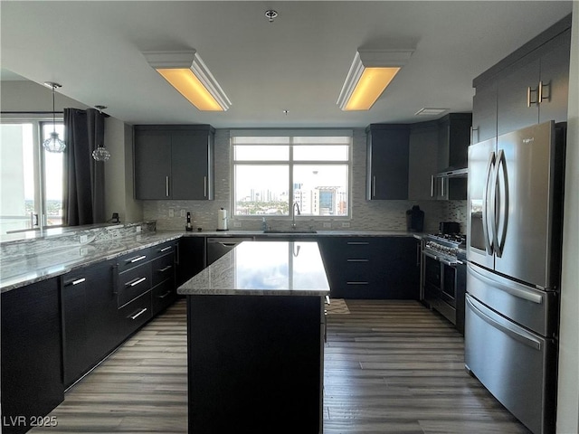150 Las Vegas Blvd Unit 1115, Las Vegas, NV 89101 - kitchen featuring appliances with stainless steel finishes, backsplash, light wood-type flooring, and light stone counters