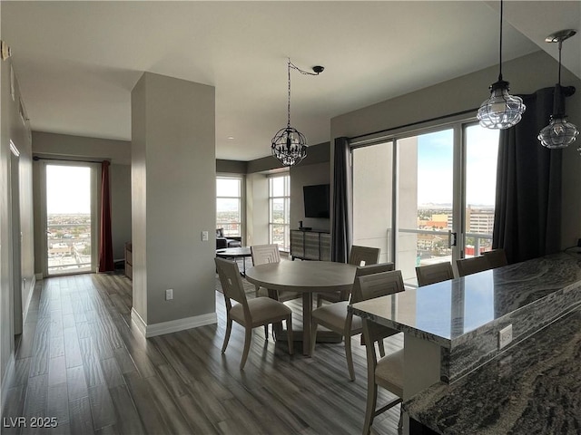 150 Las Vegas Blvd Unit 1115, Las Vegas, NV 89101 - dining space featuring a chandelier, dark wood-style flooring, and healthy amount of natural light