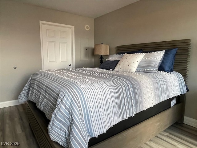 150 Las Vegas Blvd Unit 1115, Las Vegas, NV 89101 - bedroom featuring baseboards and wood finished floors