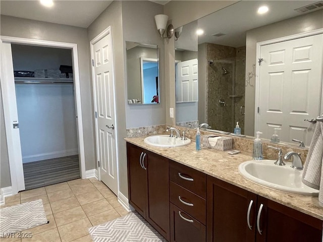 150 Las Vegas Blvd Unit 1115, Las Vegas, NV 89101 - full bathroom featuring a stall shower, tile patterned flooring, double vanity, and a walk in closet