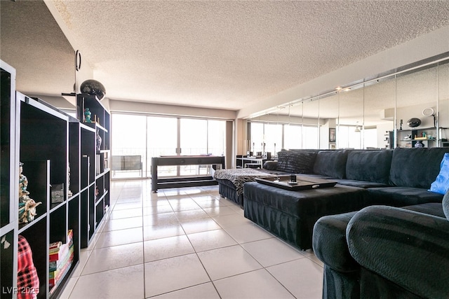 3111 Bel Air Dr Unit 9E, Las Vegas, NV 89109 - living room featuring rail lighting, light tile patterned floors, and a textured ceiling